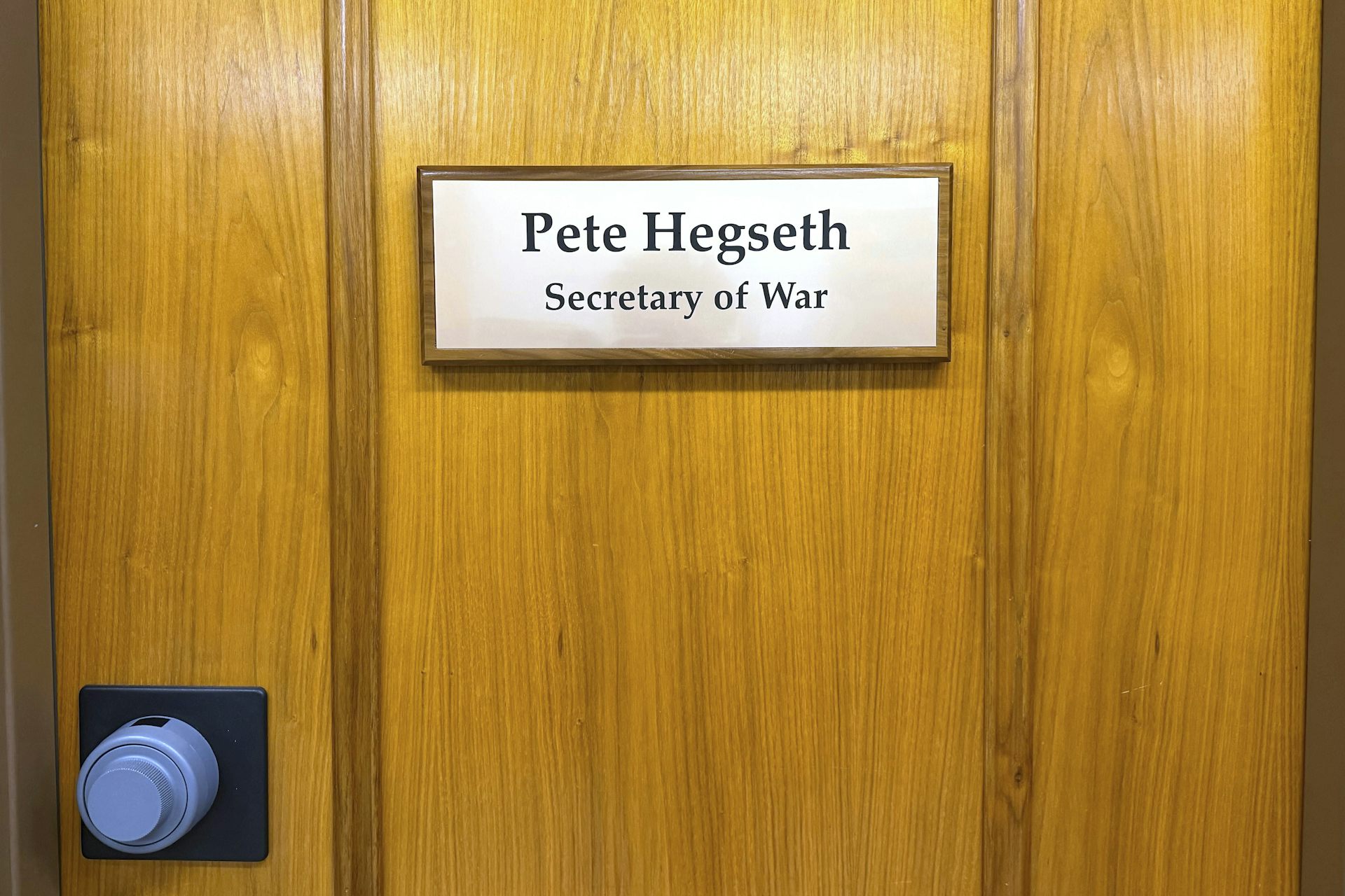 A sign on a door reads Pete Hegseth, Secretary of War.