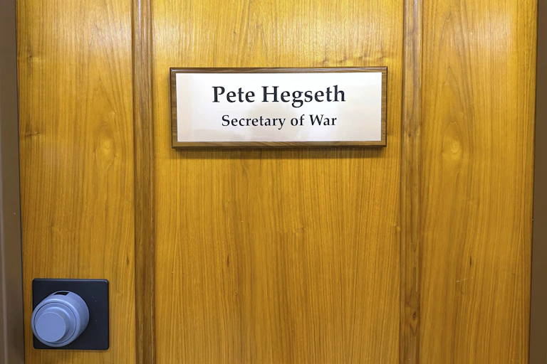 A sign on a door reads Pete Hegseth, Secretary of War.
