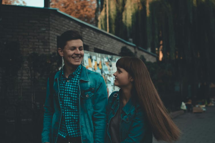 A smiling couple walking outside