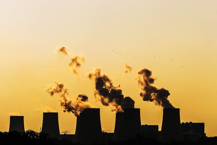 coal power station smokestacks belching smoke.