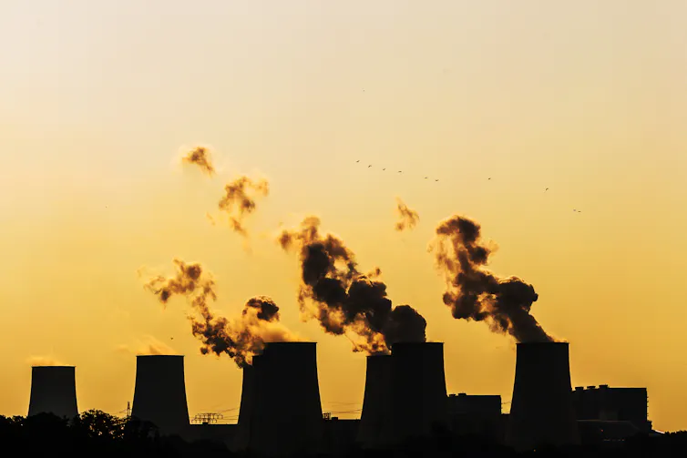 coal power station smokestacks belching smoke.