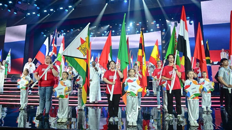 Delegates to the 2024 Brics Games holding up their national flags.