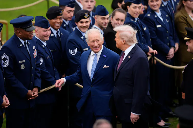 The king and the US president meeting troops.