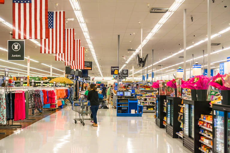 us supermarket aisles with stars and stripes flags hanging from overhead.