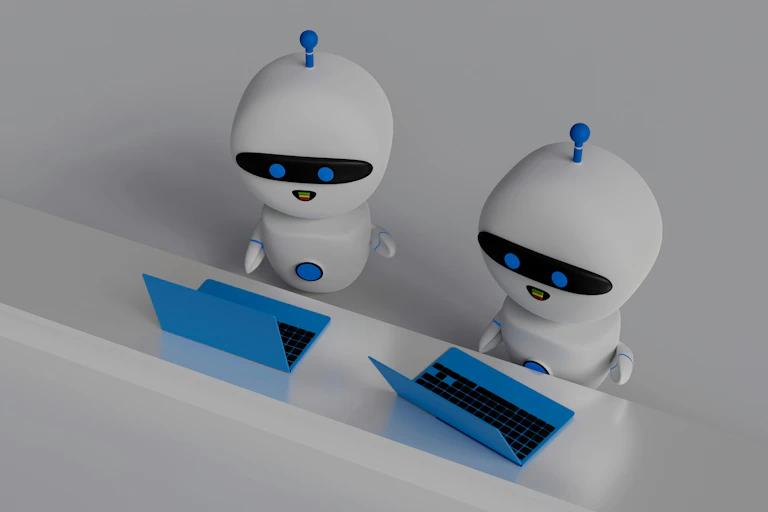 A rendering of two robots in front of their computers.