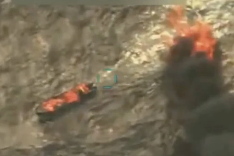 An aerial image shows two vessels at sea on fire.