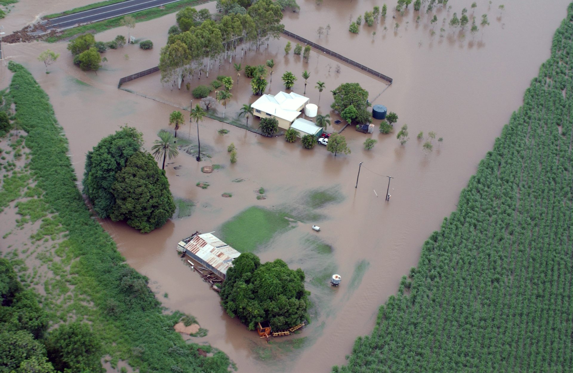 farmhouses and crops on flooded land