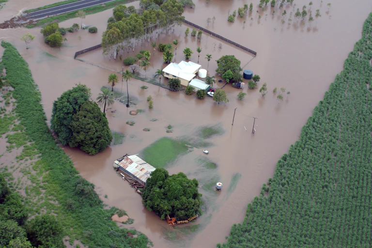 farmhouses and crops on flooded land