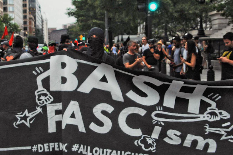 A group of protesters hold up a sign reading 'Bash Fascism' at a rally in Washington, August 2018.