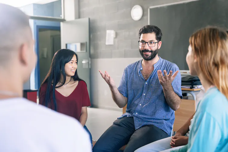 Teacher and pupils in discussion group