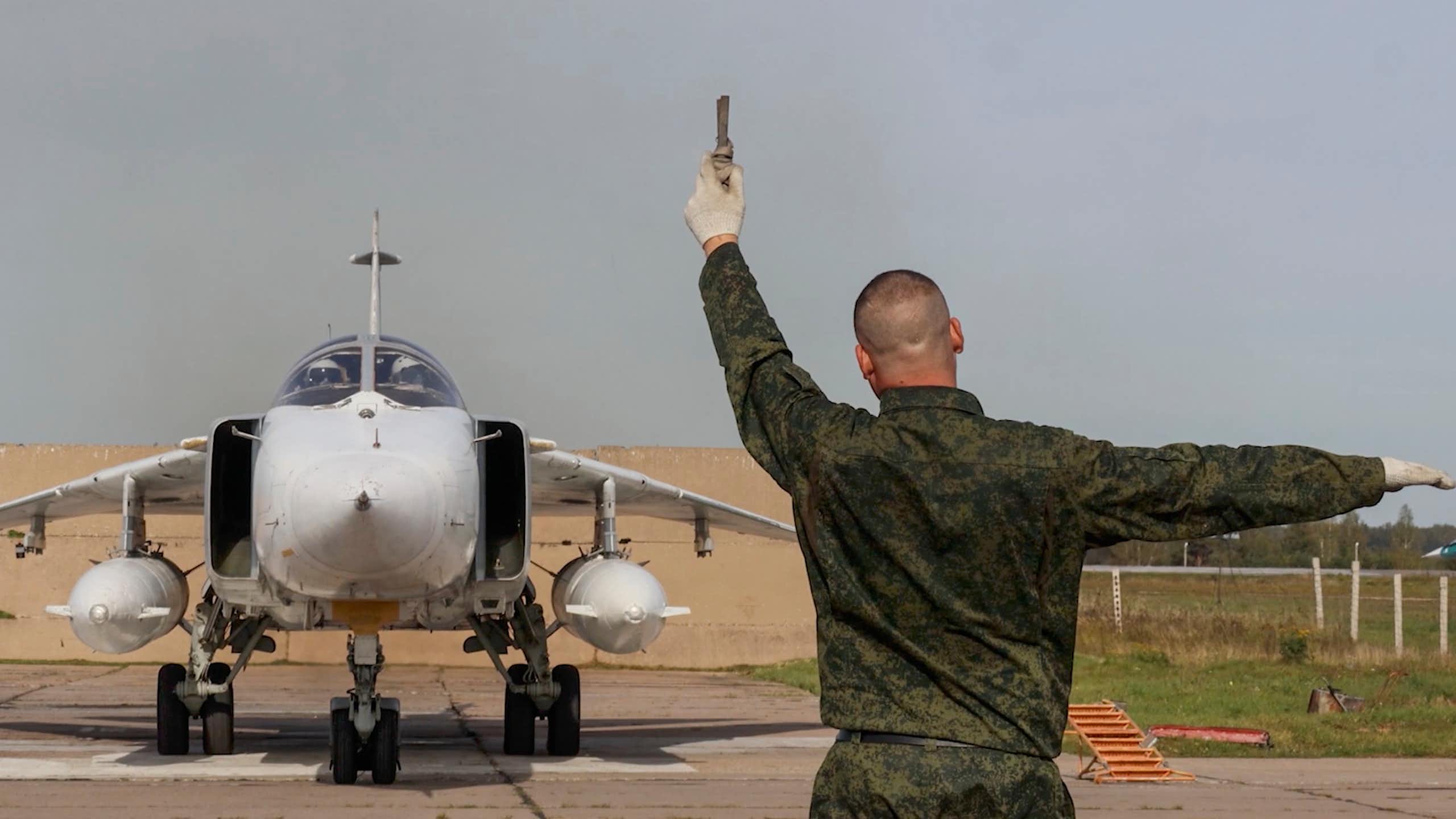 Russian ground crew member directs the pilot of a MIG aircraft preparing to take off, September 2025.