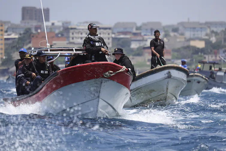 Venezuelan police officers in motorboats.