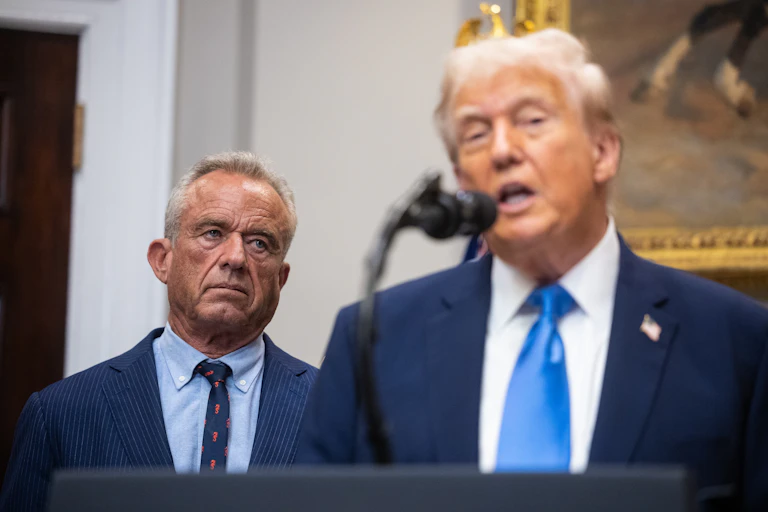 President Trump with Robert F. Kennedy Jr. in the background.