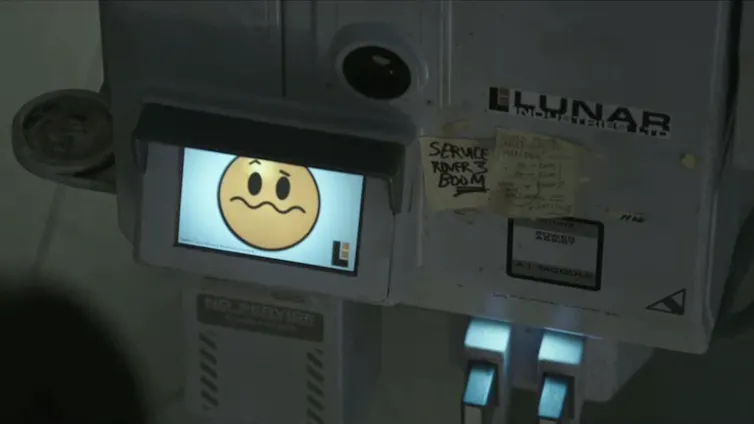 Console featuring a small screen with a yellow face whose mouth is contorted to indicate confusion.