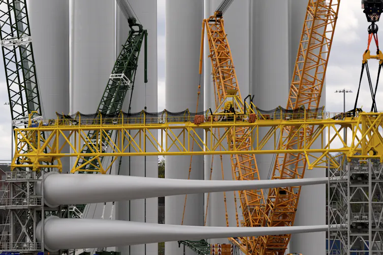 wind turbine components await assembly on a pier in connecticut