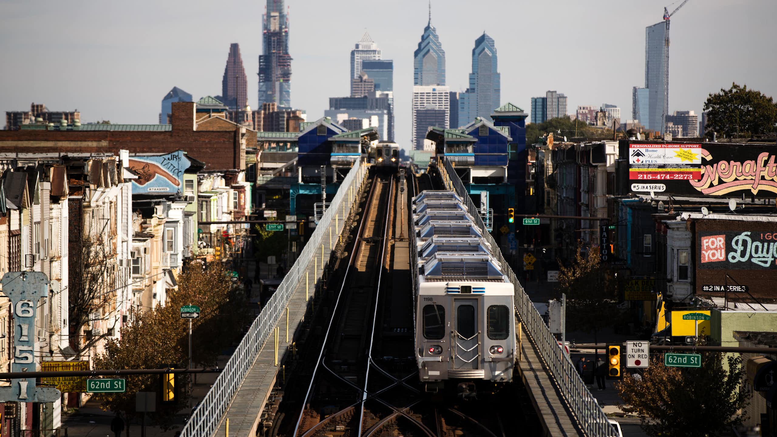 View of elevated train on tracks with Philadelphia skyline in background