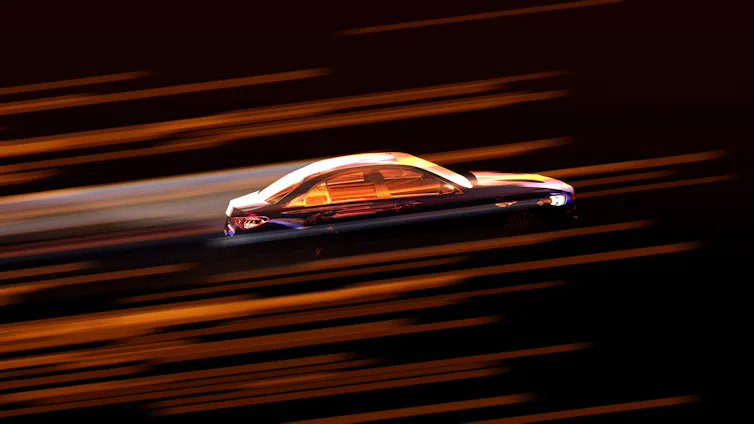a car driving fast with light traces