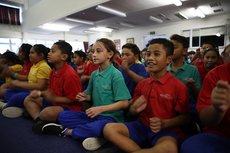 Students sitting on the mat in class