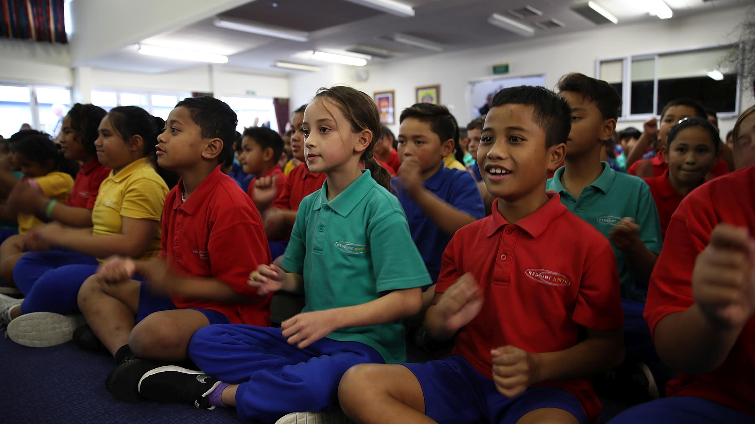 Students sitting on the mat in class