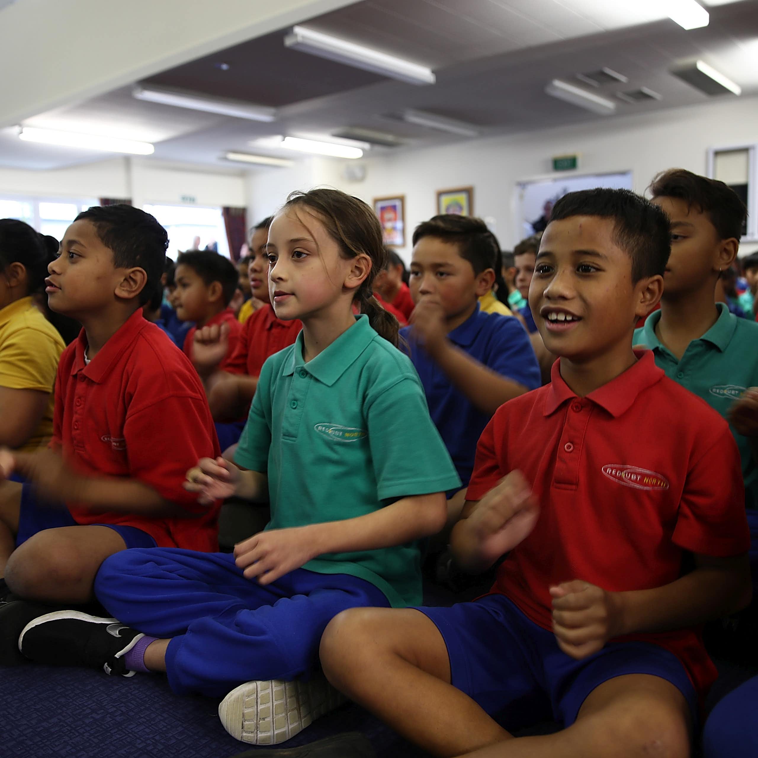 Students sitting on the mat in class