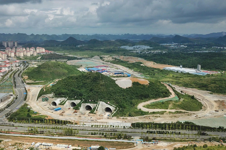 Ariel photo of tunnels being dug into a mountainside.