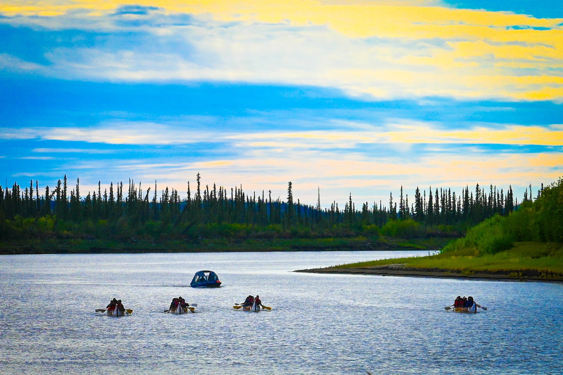 Boats seen on the water under a bright sky.