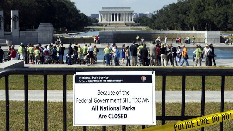 A sign in front of a national memorial.