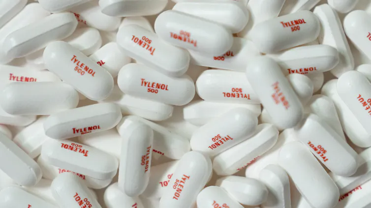 a bunch of white pills are shown with the words tylenol 500 on them in red