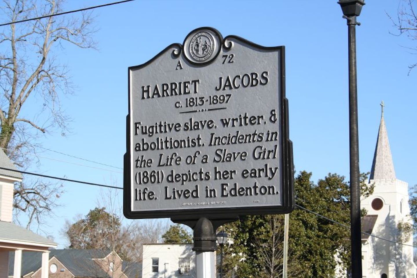 A sign reading 'Harriet Jacobs: fugitive slave, writer, and abolitionist. 'Incidents in the Life of a Slave Girl' depicts her early life. Lived in Edenton.'