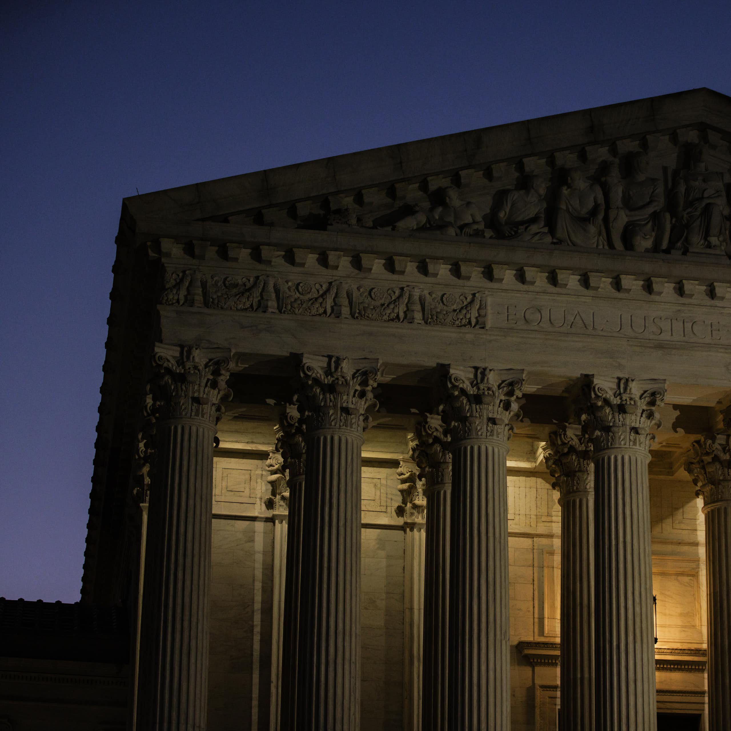 A large white, columned building at dawn.