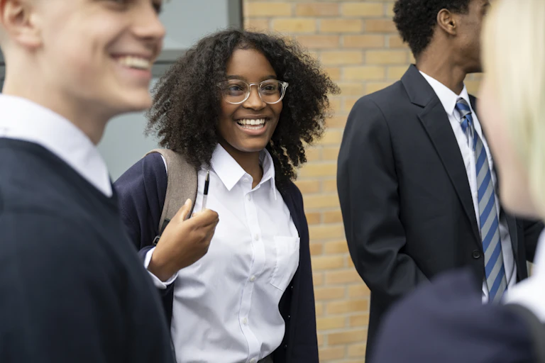 High school students in uniform smiling