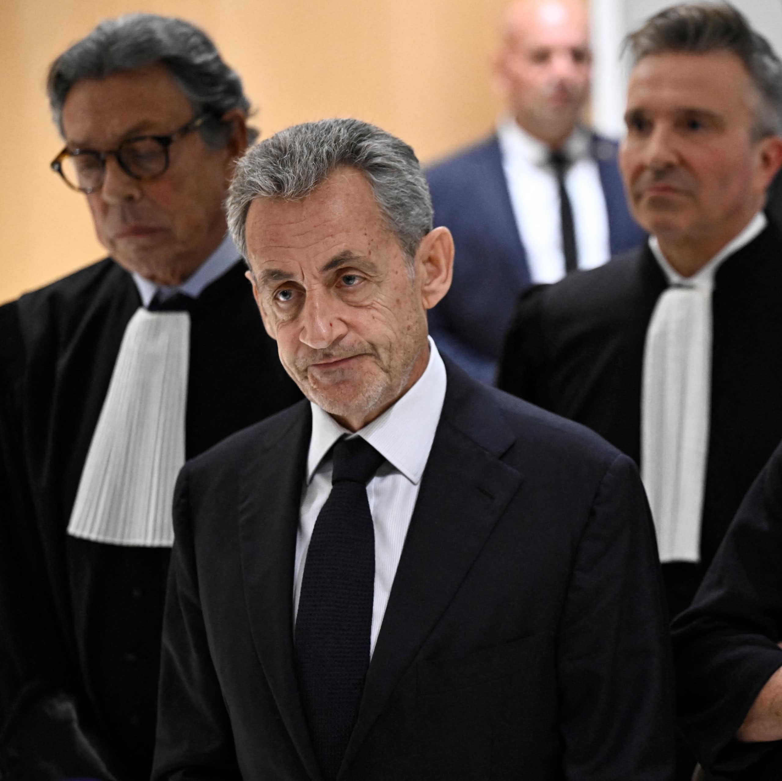 Former French president Nicolas Sarkozy leaves the courthouse on 25 September 2025 after being sentenced to five years in jail for criminal conspiracy over attempts to raise campaign funds from Libya. He is with his 2 lawyers and wife Carla Bruni.