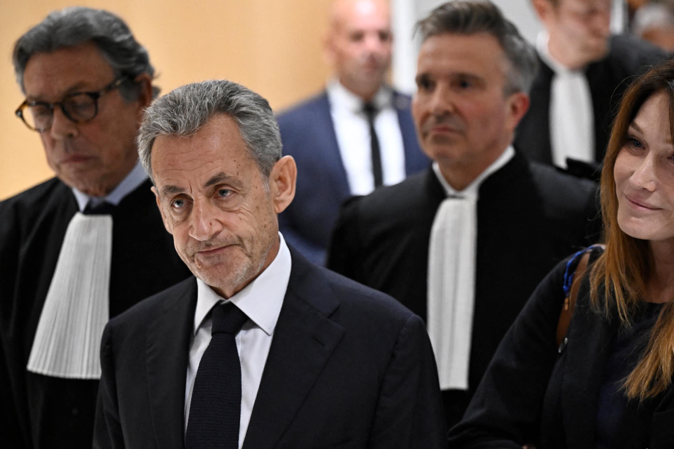 Former French president Nicolas Sarkozy leaves the courthouse on 25 September 2025 after being sentenced to five years in jail for criminal conspiracy over attempts to raise campaign funds from Libya. He is with his 2 lawyers and wife Carla Bruni.