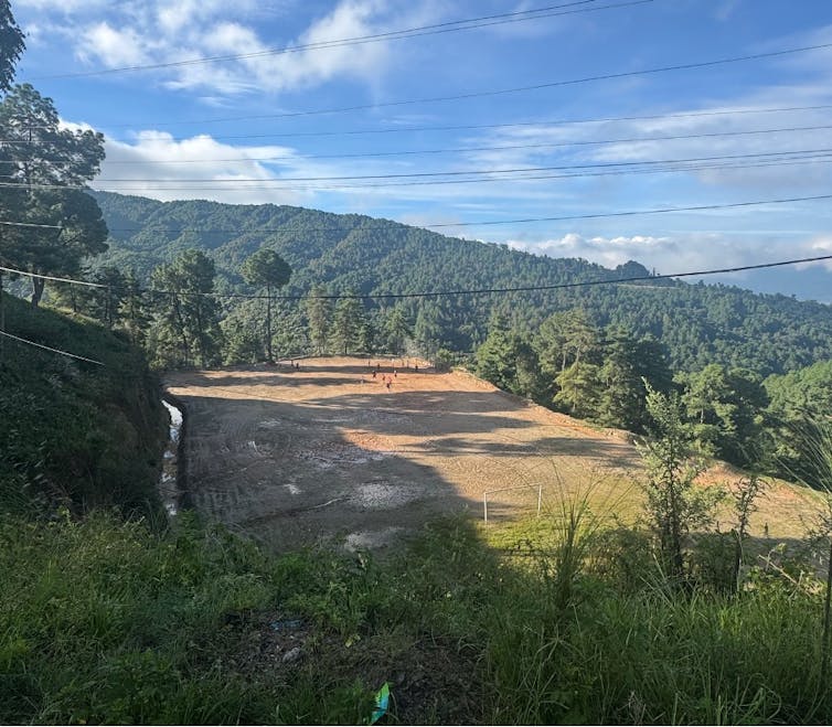 A grassroots football team practising on a rural pitch in Nepal.