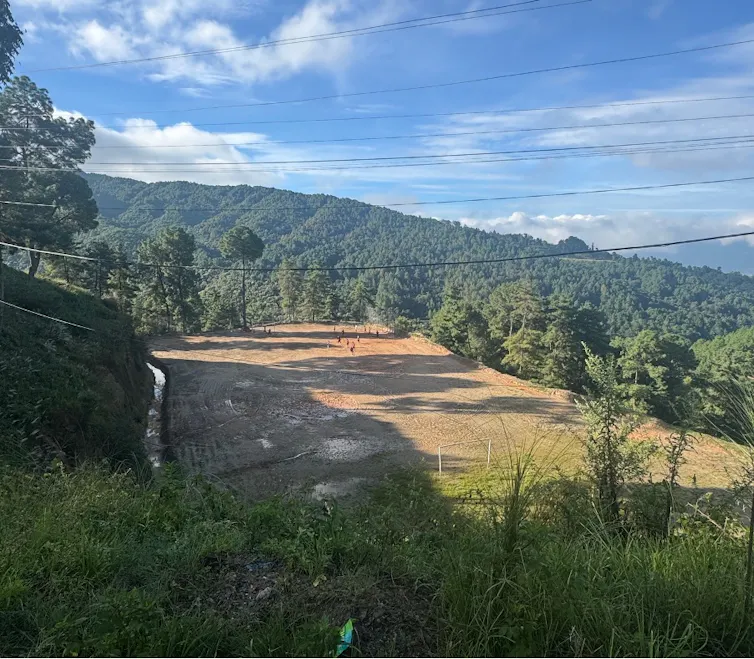 A grassroots football team practising on a rural pitch in Nepal.