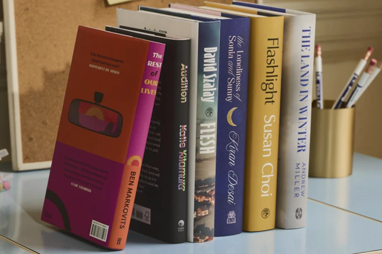 A row of six books nominated for the 2025 Booker Prize.