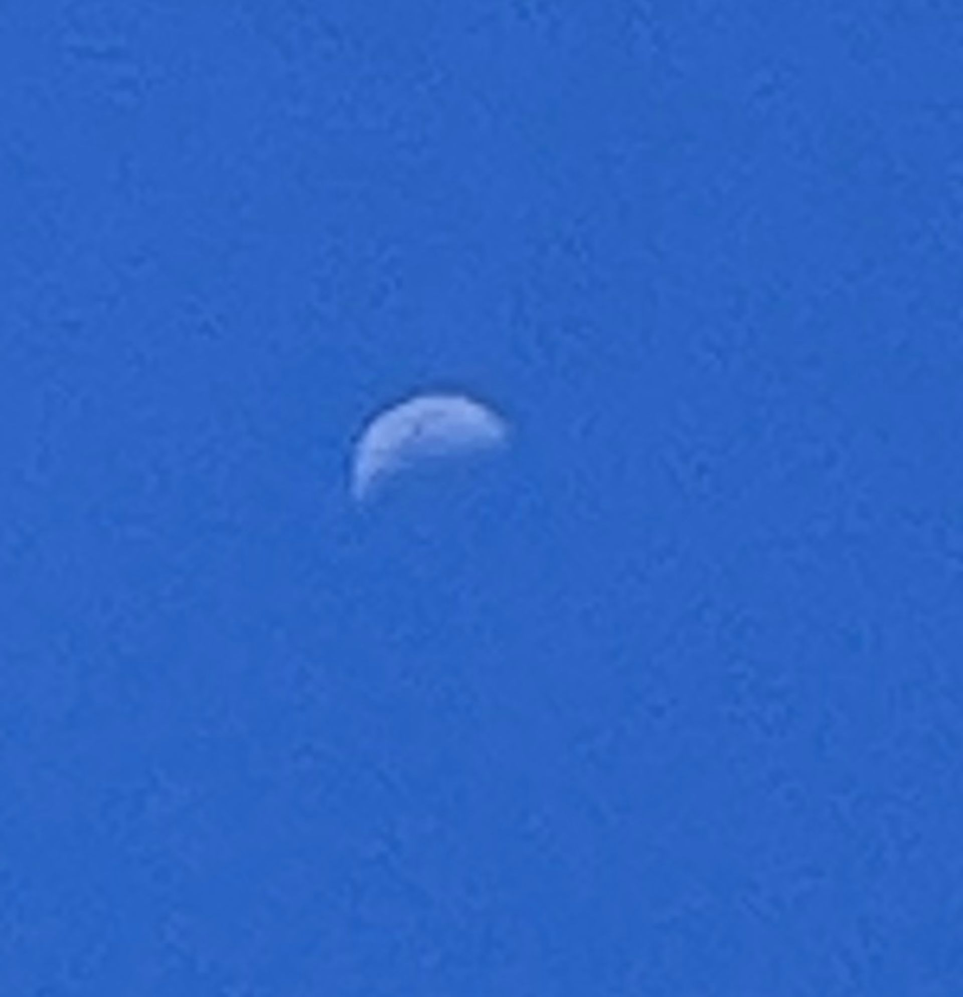 A daylight phone photo of the Moon
