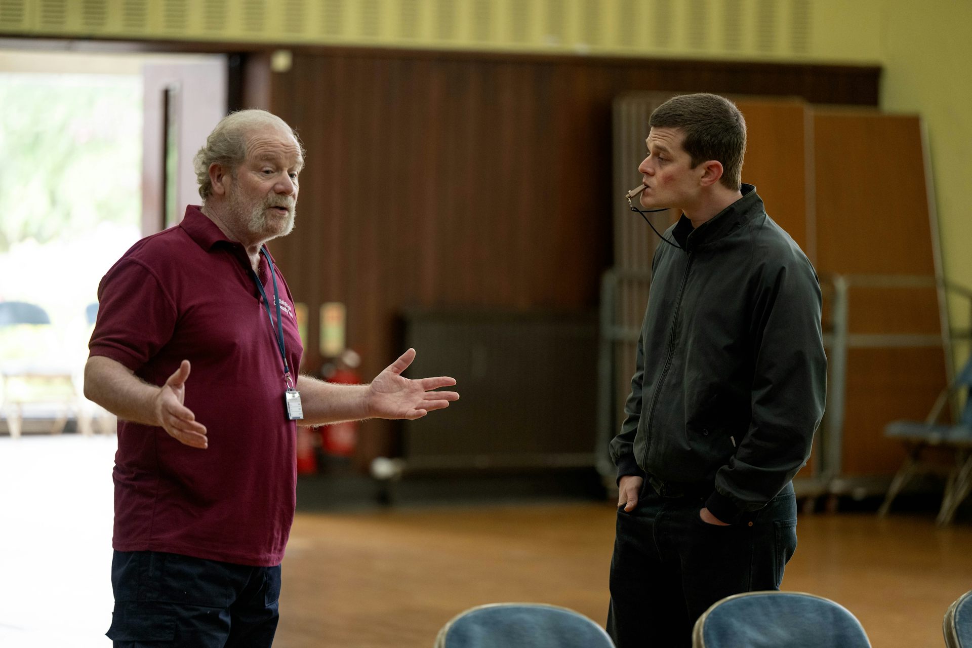 Two men in a community hall