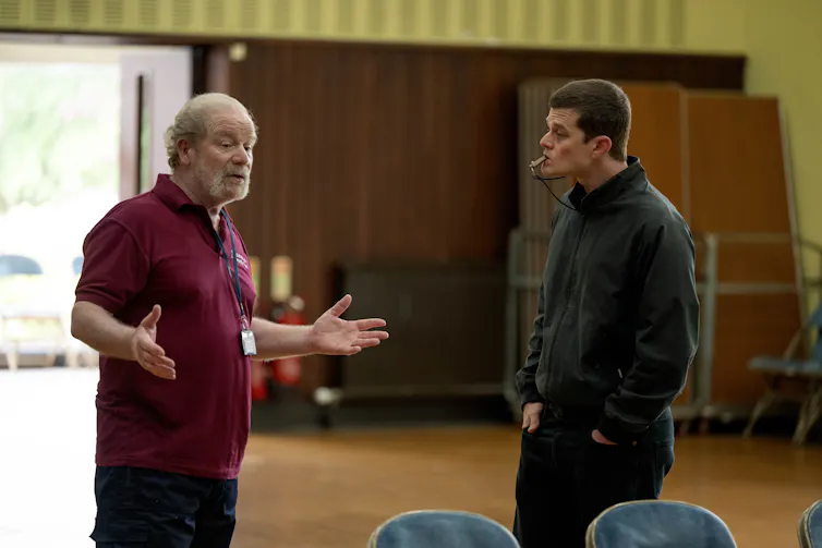 Two men in a community hall