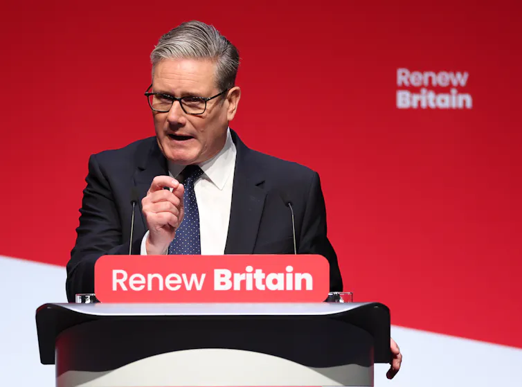 Keir Starmer giving a speech next to a slogan saying 'Renew Britain'