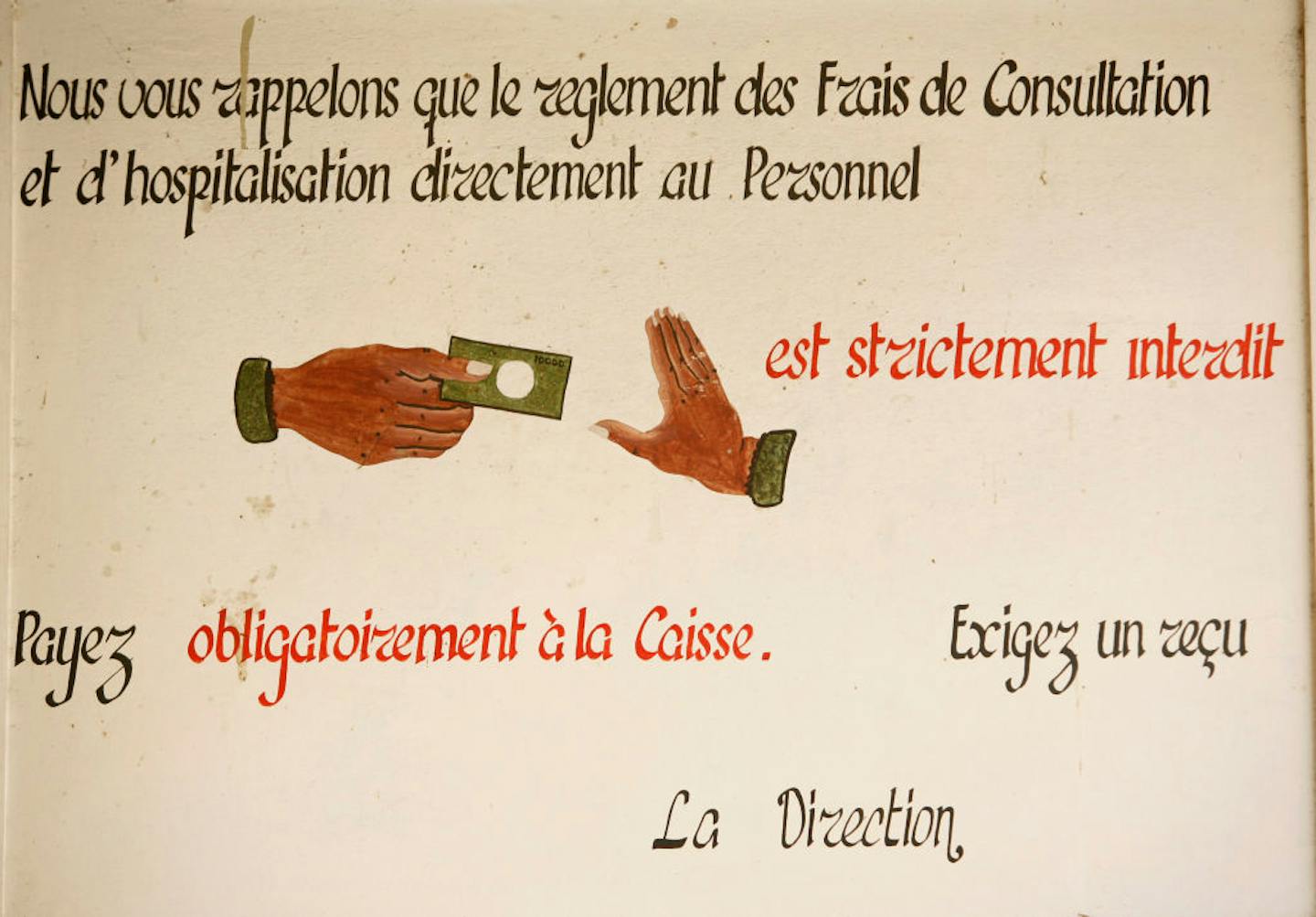 A beige sign with illustrations of one hand holding money reaching out toward another hand signaling 'stop.'