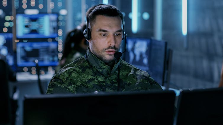 A military command centre showing a man operating drones.