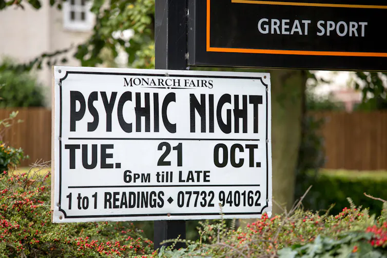 A poster outside of a pub advertising a psychic night
