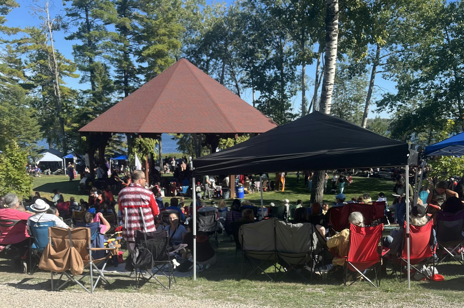 People sitting on chairs outdoors.