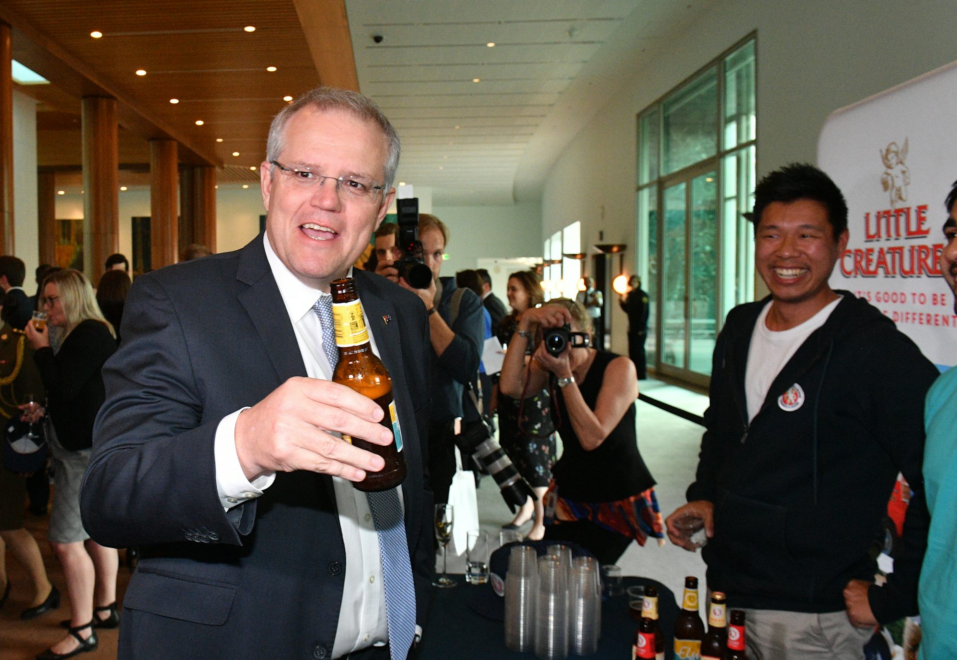 Prime Minister Scott Morrison at a Showcase WA event holding what looks like a beer.
