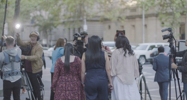The sisters at a press conference.