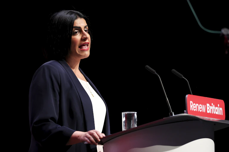 Side view of Shabana Mahmood speaking at Labour conference at a podium that reads 'Renew Britain'