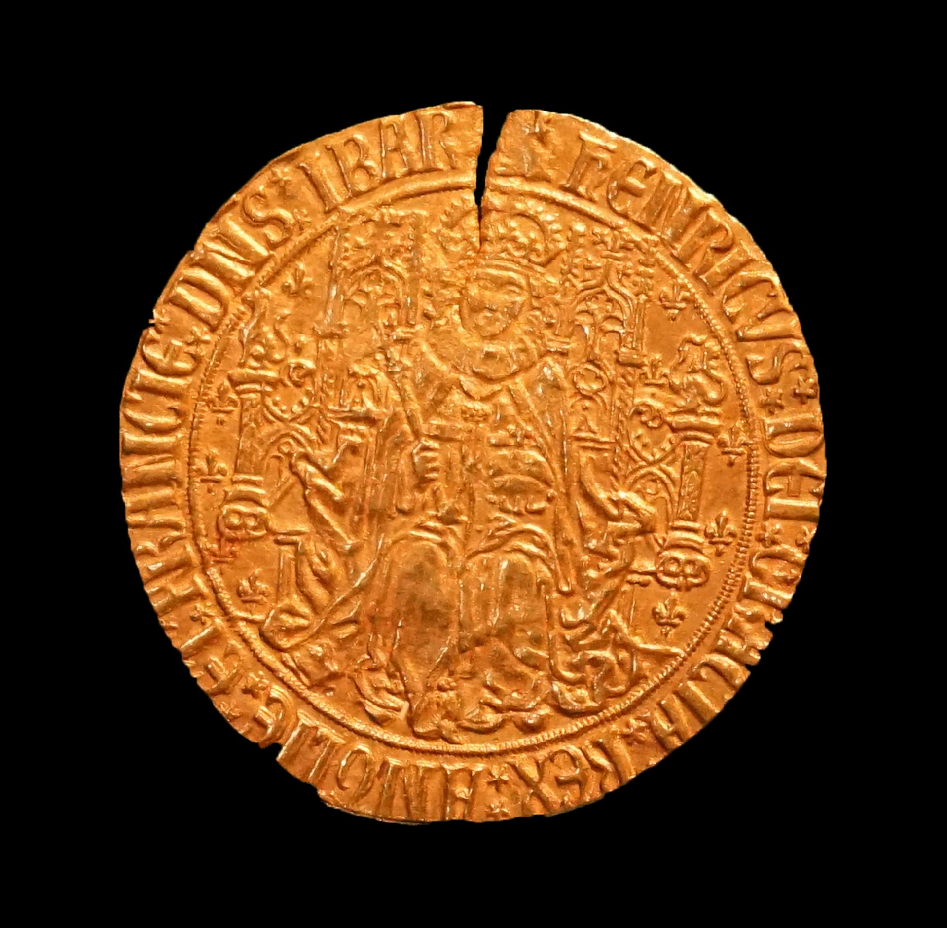 A gold coin with a crack in the top of it from the Tudor period.