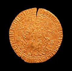A gold coin with a crack in the top of it from the Tudor period.
