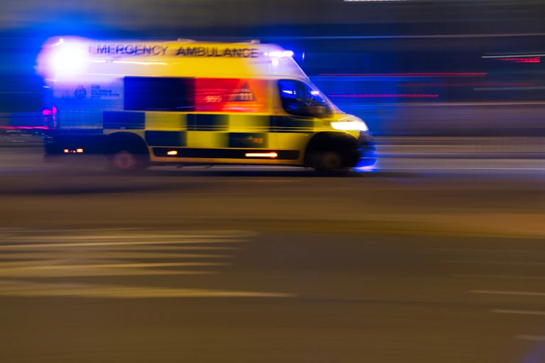 Blurred image of ambulance in motion.